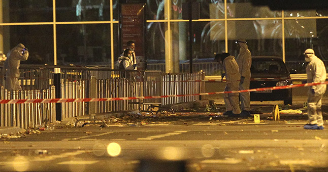 Investigating police officers work outside the Stade de France stadium after an explosion and after international friendly soccer match France against Germany, in Saint Denis, outside Paris, Friday Nov. 13, 2015. Multiple fatal attacks throughout the city have prompted President Francois Hollande to announce he was closing the country's borders and declaring a state of emergency. (AP Photo/Michel Spingler)